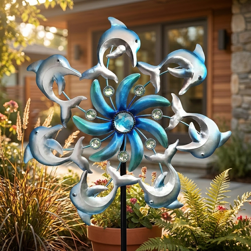 Dolphin wind spinner garden stake in a sunlit patio garden
