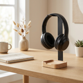 Solid wood headphone stand styled on a bright modern home-office desk