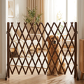 Retractable wooden pet gate standing upright across a bright living-room doorway